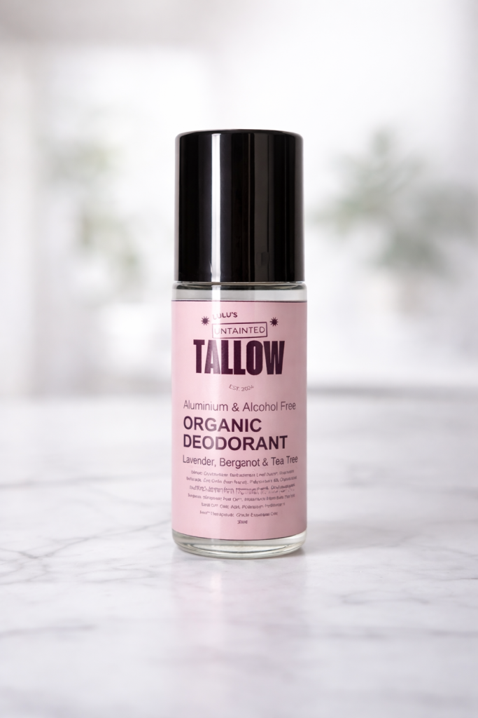 Natural magnesium roll-on deodorant by Lulu’s Untainted Tallow, aluminium-free and alcohol-free, with organic witch hazel and aloe, in a clear glass bottle on a white marble surface.